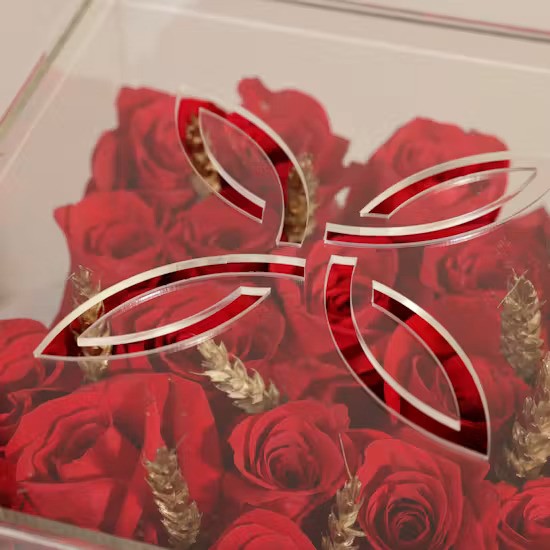 Elegant acrylic lid with stylish cutouts over red roses for a minimalist gift experience
