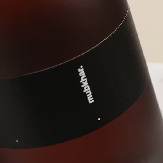 Detailed view of the dark glass diffuser bottle neck and collar design