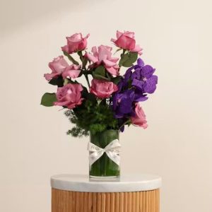 Luxury purple Vanda orchids and velvet roses arrangement in a cylinder glass vase